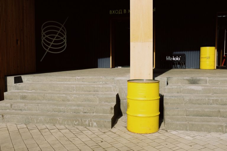 yellow-steel-drum-beside-concrete-wall-3964739.jpg