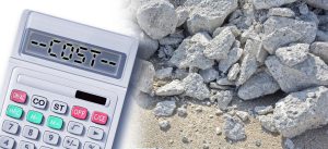 A calculator showing "COST" beside concrete rubble, symbolizing construction expenses.